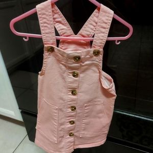 A Pink overall Dress.